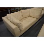 A Roche Bobois cream leather two seater sofa.