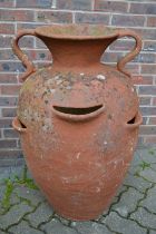 A large terracotta twin handled urn, 3ft high.