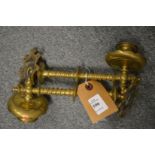 A pair of brass candle sconces.