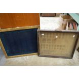 A display case for medals and a gilt framed board.