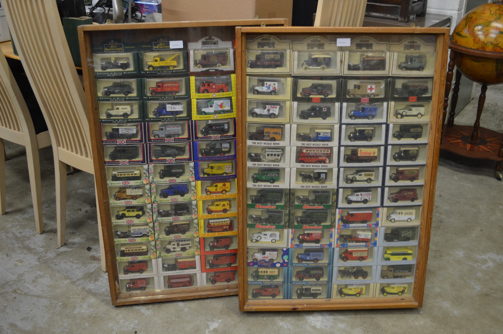 A good large collection of boxed model advertising vans contained in a pair of glazed display
