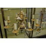 A good heavy cast brass eight branch chandelier with cherub mounts.