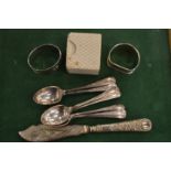 Silver napkin rings and other items.