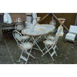 A white painted oval garden table with six matching folding chairs.