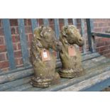 A pair of composite gate post finials modelled as horse's heads.