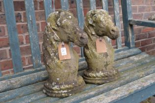 A pair of composite gate post finials modelled as horse's heads.
