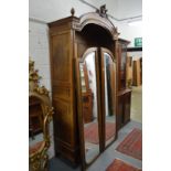 A good 19th century French walnut armoire with a pair of mirrored enclosing shelves.