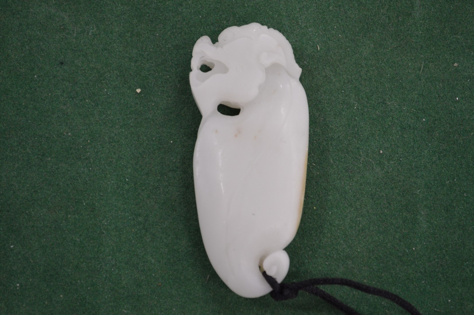 A carved jade amulet.