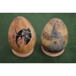 Two decorative hardstone eggs and on stands.