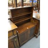 A small oak cupboard bookcase.