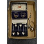 A cased set of silver coffee spoons, a cased pair of napkin rings etc.