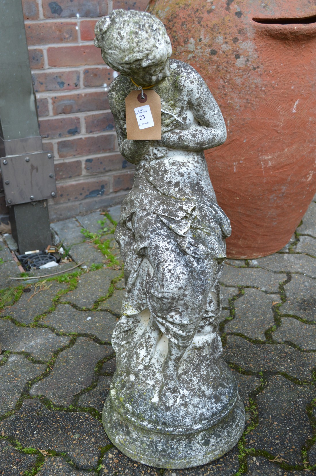 A composite garden ornament modelled as a classical young lady.