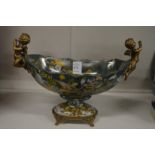 A French style porcelain and ormolu twin-handled oval pedestal bowl.
