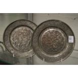 A pair of embossed metal plates depicting biblical scenes.