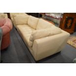 A Roche Bobois cream leather three seater settee.