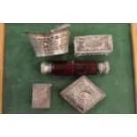 A small group of silver items and a double ended scent bottle.