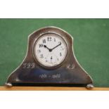 A silver desk clock.