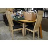 A modern extending dining table and eight high back chairs.