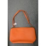 A ladies' orange handbag.