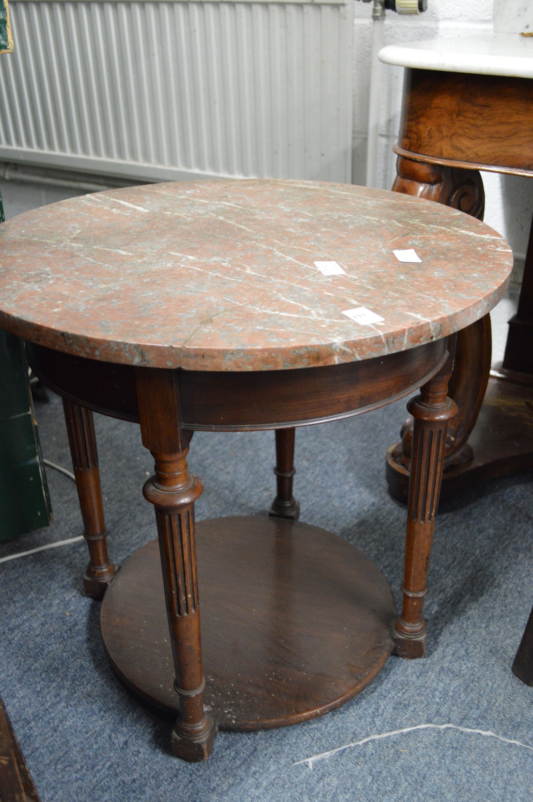 A marble and mahogany two tier circular table (marble cracked).