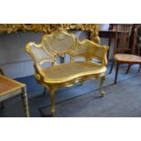 A good small French giltwood and canework upholstered settee.