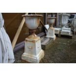 A good pair of painted cast iron pedestal urns (Note: tops are fixed to bases).