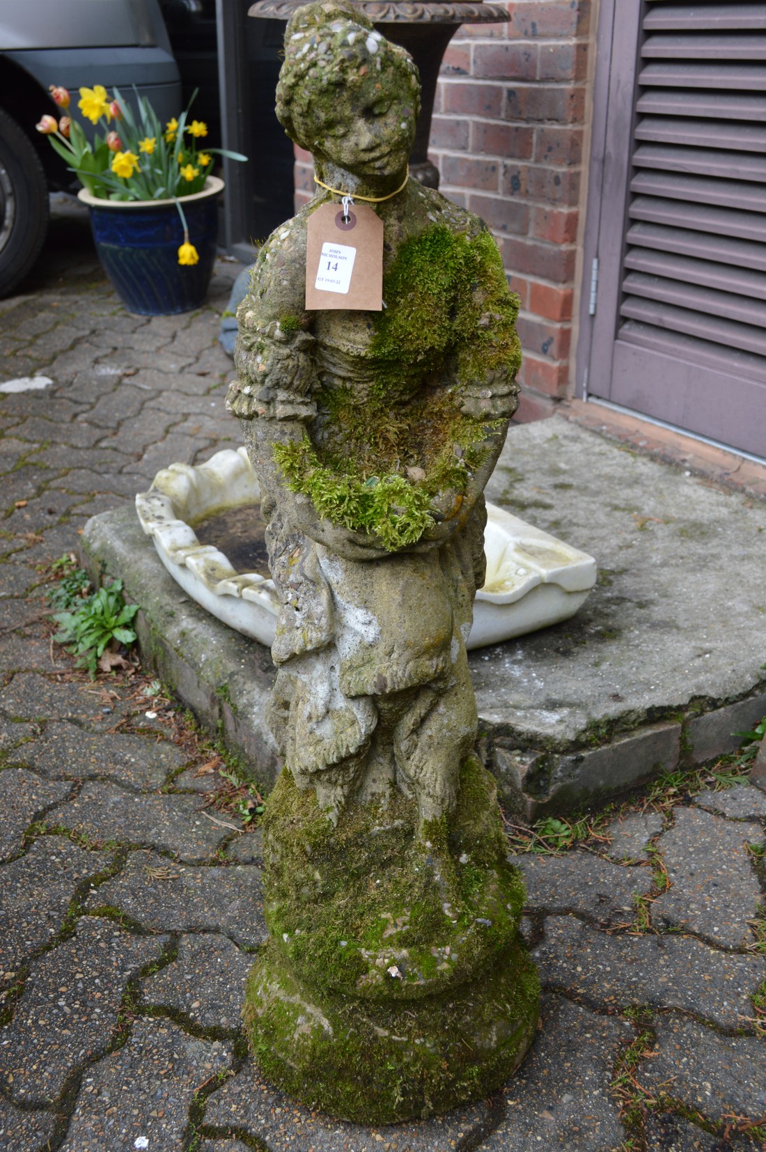 A composite garden ornament of a classical young lady.