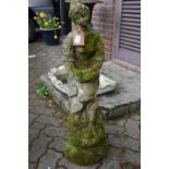 A composite garden ornament of a classical young lady.