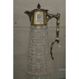 A cut glass claret jug with plated mounts.