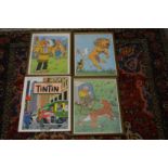 Herge, three colour prints of Tintin together with a poster book.
