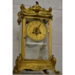 An ormolu four glass mantle clock with mercury pendulum.