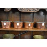A set of four copper bowls.