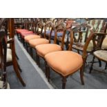 A set of four Victorian walnut dining chairs.