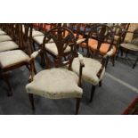 A pair of Hepplewhite style mahogany open armchairs, the oval backs with carved Prince of Wales