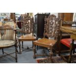 A pair of carved oak dining chairs.