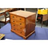 A mahogany table top four drawer chest.