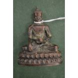 A small cast metal Buddha.