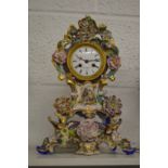 A French porcelain mantle clock on matching stand.