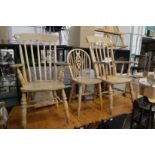 A pair of Victorian style broad arm Windsor chairs and a wheel back chair.