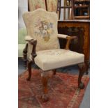 A good George III style mahogany framed open armchair with needlework upholstered back and seat on