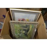 A box of paintings and prints.