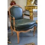 A good pair of beech framed open armchairs with green leather upholstered backs, arms and seats.