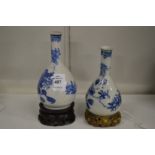 Two small Chinese blue and white bottle vases on stands.
