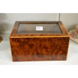A burr wood and glass topped jewellery box.