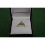 A good diamond and gold solitaire ring.