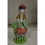 A small Chinese figure of a woman.