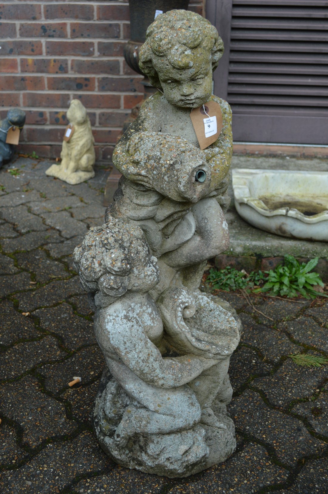A composite garden fountain modelled as two cherubs.
