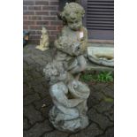 A composite garden fountain modelled as two cherubs.