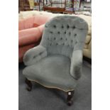 A Victorian button back armchair.