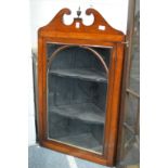 A mahogany hanging corner cabinet.